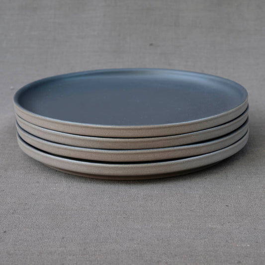 Set aus 4 grossen Steinzeug Tellern der Kollektion Lietzensee. Die Dinnerteller sind in schwarz mit unglasiertem Rand, was ihnen einen industrial Design Charme gibt